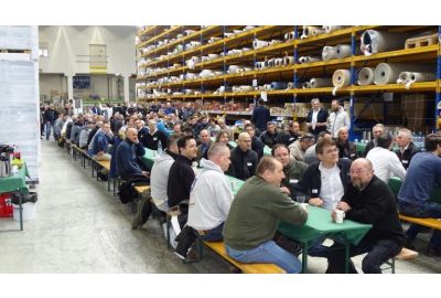 Seminarteilnehmer bei Begrüßung sitzend auf Bänke